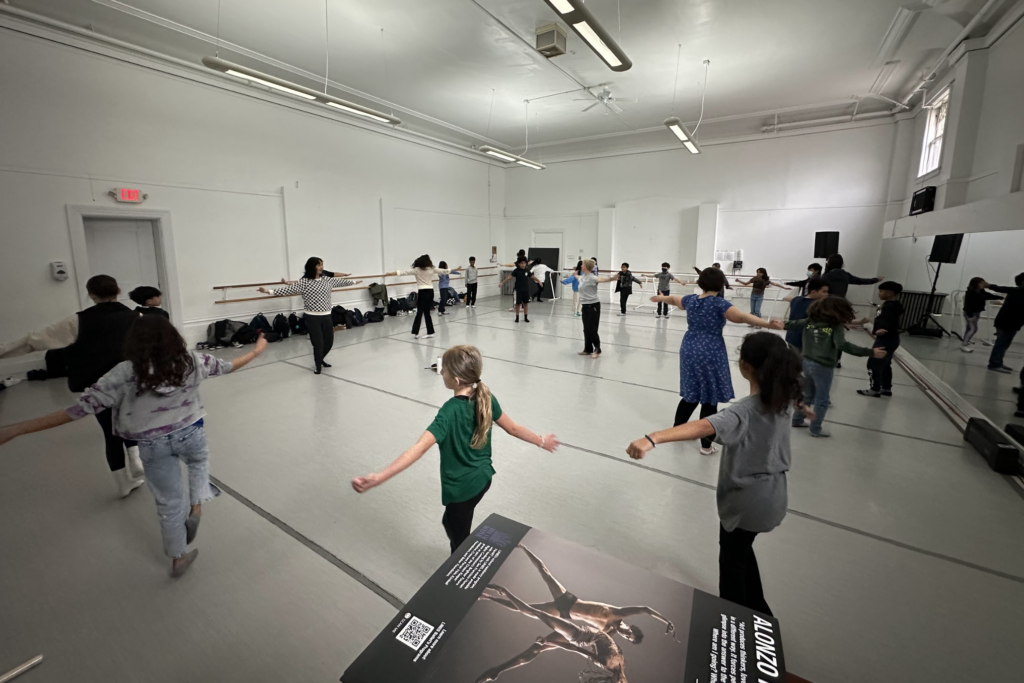 Students from Glen Park Elementary School dancing in a studio at LINES Dance Center on a field trip
